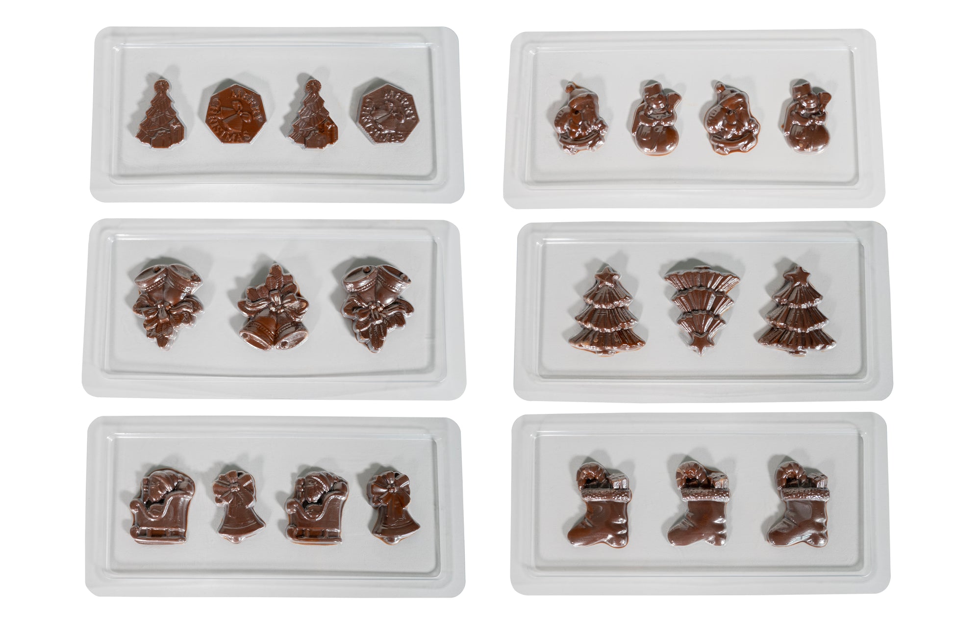 Sechs weiße Tabletts aus der Chocolatier Weihnachtsedition von Unold zeigen glänzende Schokoladenstücke in Form von Weihnachtsbäumen, Strümpfen, Glocken, Schneemännern und anderen festlichen Weihnachtsmotiven auf weißem Hintergrund.