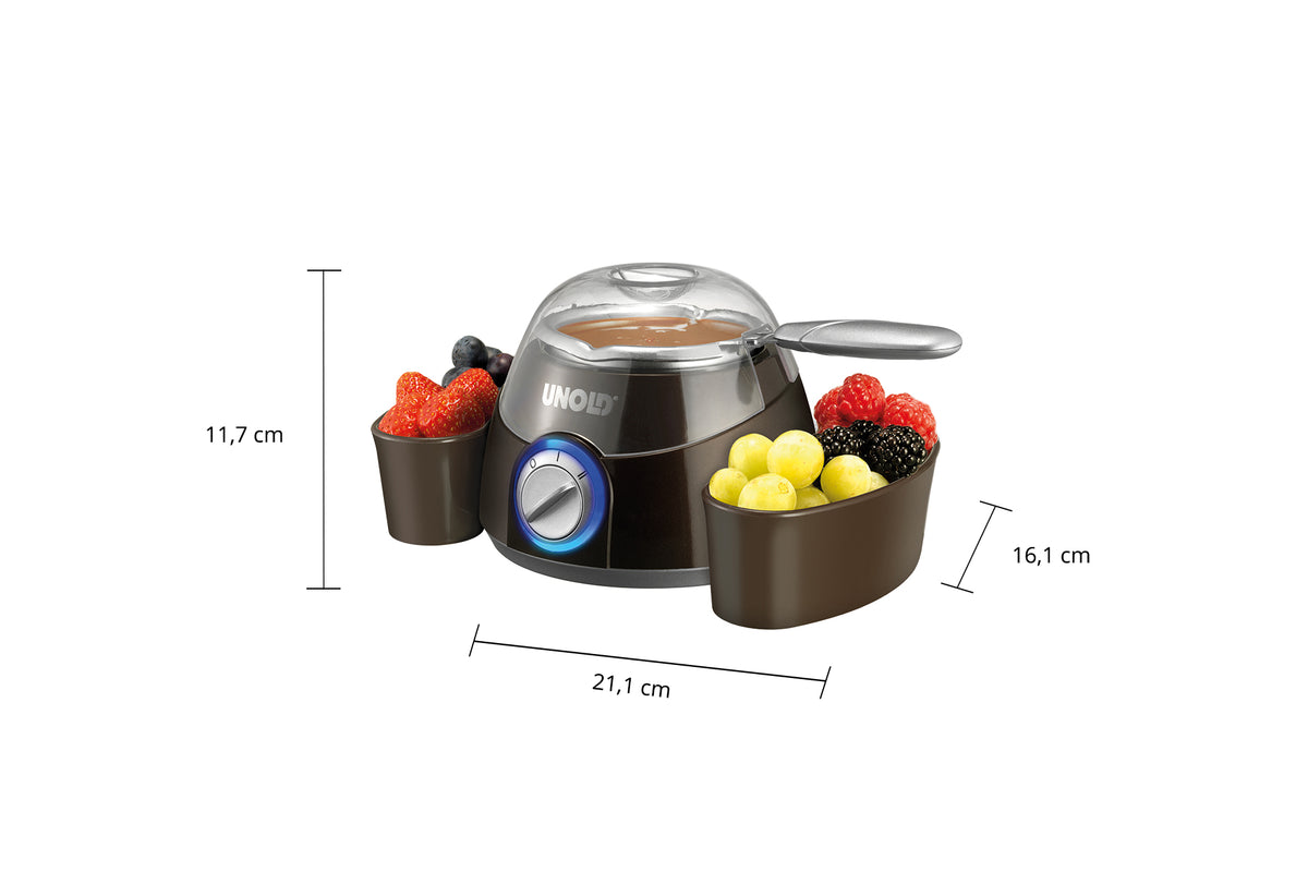 Die Unold Chocolatier Weihnachtsedition verfügt über einen transparenten Deckel, einen Temperaturregler und wird mit Schalen für Erdbeeren, Trauben, Himbeeren und Brombeeren geliefert. Maße: 11,7 cm hoch, 16,1 cm breit, 21,1 cm lang.