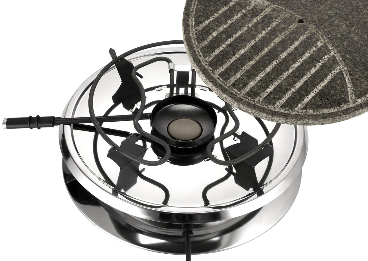 Eine Draufsicht des Unold Raclette Multi 4 in 1 inklusive Raclette Buch zeigt glänzendes Metall, schwarze Brennerroste und einen runden, strukturierten grauen Grillstein, der die Oberfläche teilweise bedeckt.