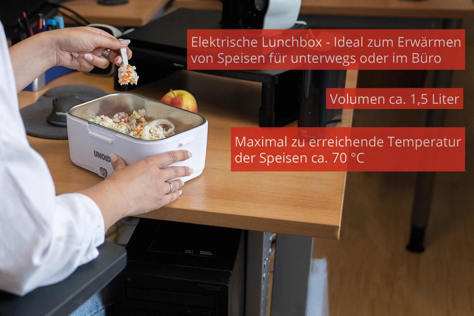 Eine Person nutzt die Unold Lunchbox zum Aufwärmen von Speisen am Schreibtisch. Der deutsche Text beschreibt ihre Eigenschaften: Ideal für unterwegs oder im Büro, fasst sie 1,5 Liter und erwärmt Speisen auf ca. 70 °C.