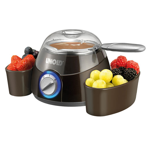 Der Unold Chocolatier ist eine Schokoladenfondue-Maschine mit einem zentralen Topf für geschmolzene Schokolade und zwei seitlichen Tabletts für Erdbeeren, Weintrauben, Brombeeren und Heidelbeeren.