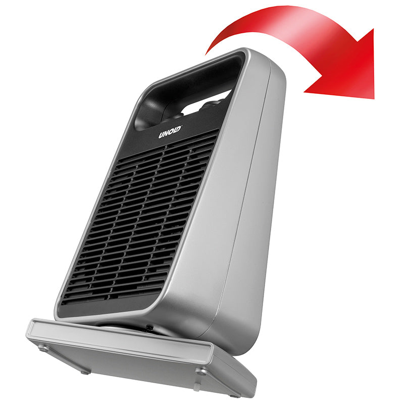 Der Unold HEIZLÜFTER ROTATE ist ein grauer tragbarer Heizlüfter mit schwarzem Frontgrill, der schräg auf seinem Sockel steht. Ein großer roter Pfeil darüber zeigt die Luftstromrichtung an.
