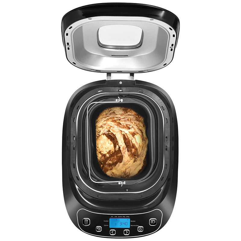 Eine Draufsicht auf den Brotbackautomaten Unold 68010 Backmeister® Design von Unold zeigt den Teig im Inneren, der zum Backen bereit ist. Das Bedienfeld, die Tasten und die Digitalanzeige sind auf der Vorderseite sichtbar.
